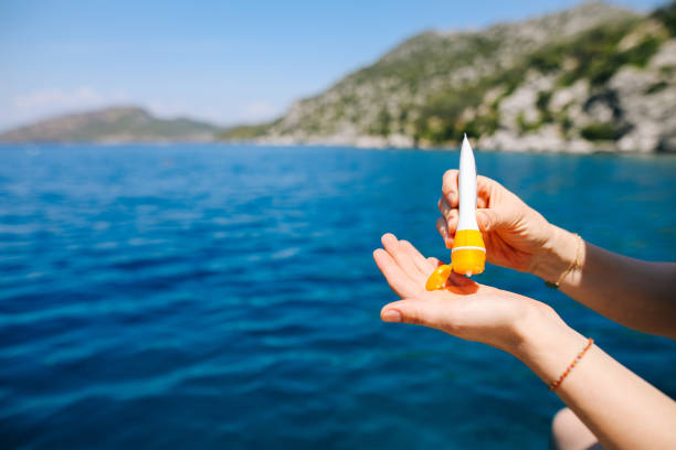 istock Woman hand apply sunscreen on the beach 1152438451