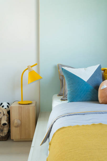 istock Many dolls setting on bed with pillows in kid bedroom. 1152439548