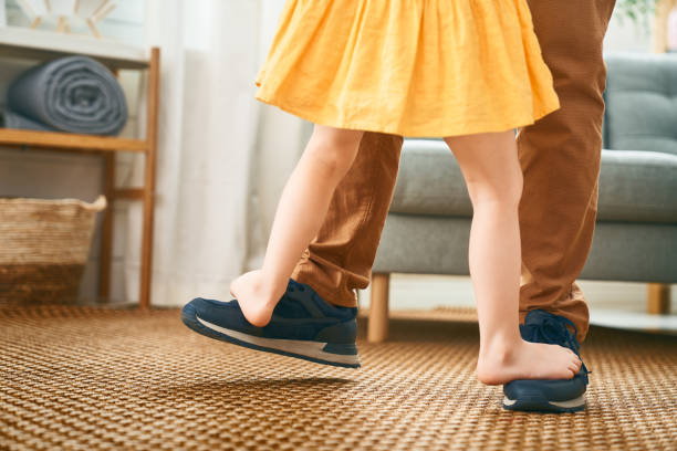 child is playing with parent Happy father's day! Dad and his daughter child girl are dancing. Family holiday and togetherness. dancing dad stock pictures, royalty-free photos & images