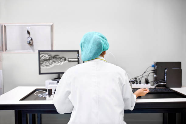 Laboratory technician performing in vitro fertilization stock photo