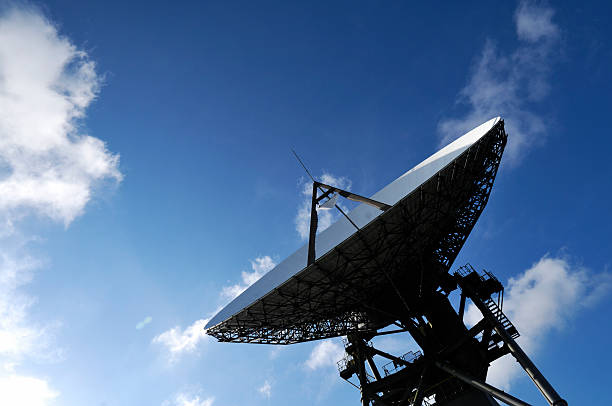 Satellite dish pointing to the blue sky stock photo