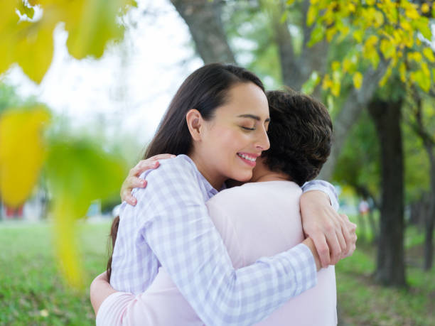 istock Young woman tenderly hugging her mother 1152444700
