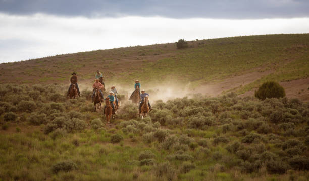 istock Ranchers galloping on horses in Utah, USA 1152445028