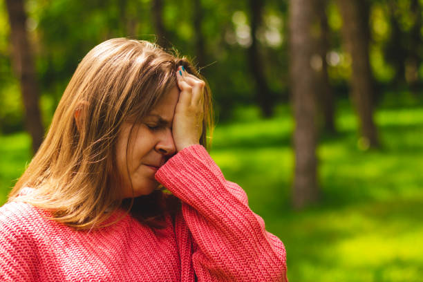 istock Woman holding one hand on the forehead while in pain 1152445903