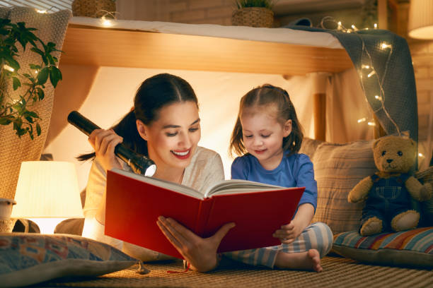 istock Mom and child reading a book 1152446295