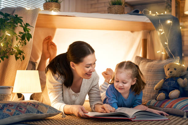 istock Mom and child reading a book 1152446321