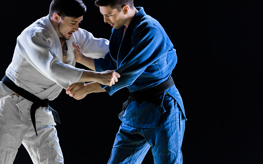 Male Judo Players Competing During Match