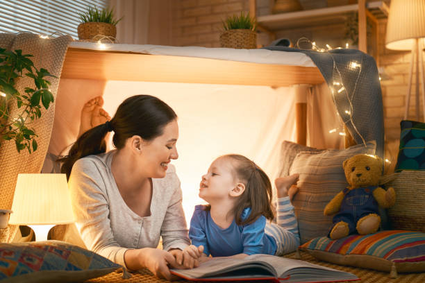 istock Mom and child reading a book 1152446374