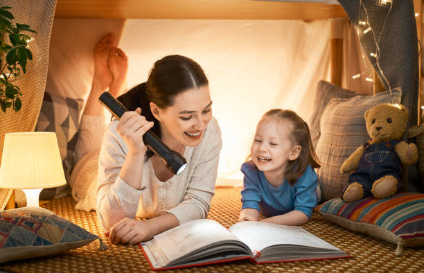 istock Mom and child reading a book 1152446386