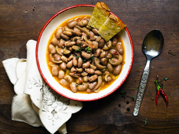 Rustic bean and pork rinds soup, Italian food stock photo