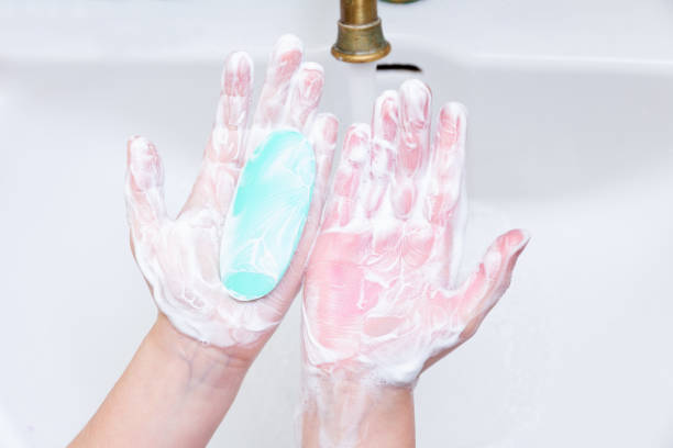 istock Baby hands wash with soap in a white sink after a walk. 1152447390