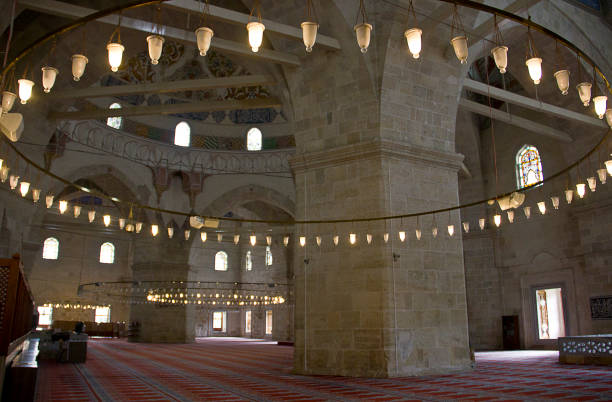 Edirne three Şerefeli Mosque, Uc Serefeli Mosque Edirne, Turkey - April 19, 2019: People pray in mosque called 3 şerefeli cami (Uc Serefeli mosque) Mosque in the center of city of Edirne, East Thrace, Turkey. The Üç Serefeli Mosque, named after its unusual minaret with three balconies (serefe), was built between 1438. unesco organised group stock pictures, royalty-free photos & images