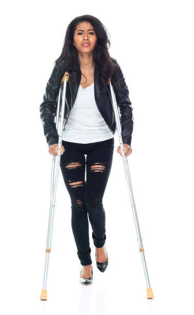 istock Bautiful woman wearing a leather jacket and using crutches 1152448948