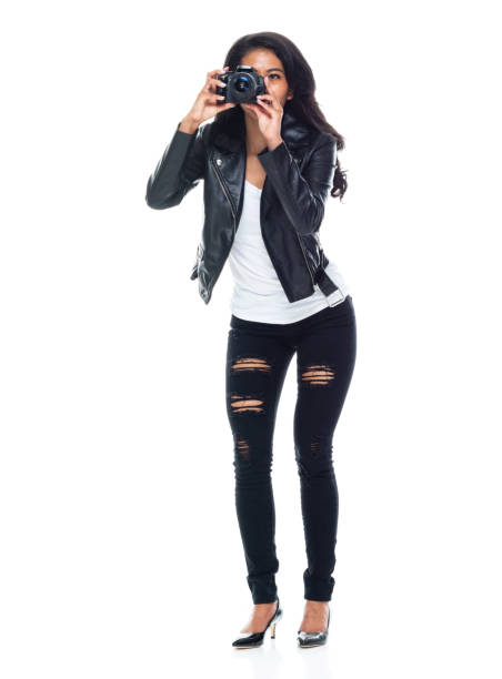 istock Bautiful woman wearing a leather jacket sitting and using a DSLR camera 1152449606