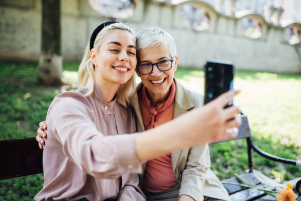 istock Girl taking a selfie with mother 1152449966
