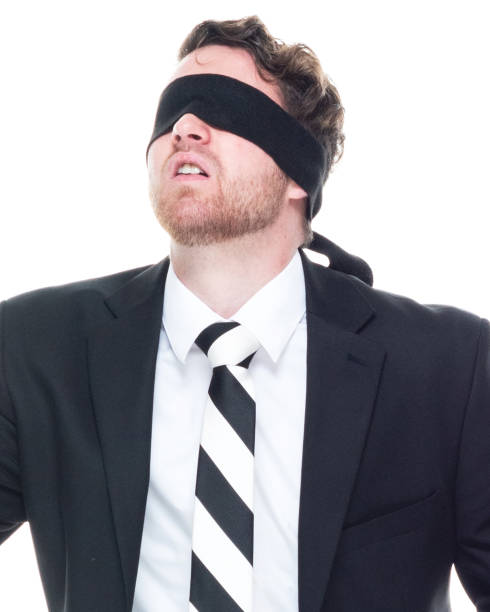 istock Handsome businessman wearing a black suit - is wearing a blindfold 1152450173
