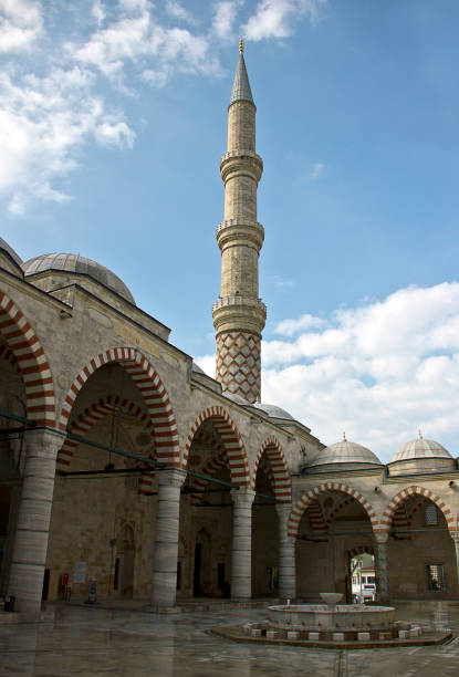 Edirne three Şerefeli Mosque, Uc Serefeli Mosque People pray in mosque called 3 şerefeli cami (Uc Serefeli mosque) Mosque in the center of city of Edirne, East Thrace, Turkey. The Üç Serefeli Mosque, named after its unusual minaret with three balconies (serefe), was built between 1438. unesco organised group stock pictures, royalty-free photos & images