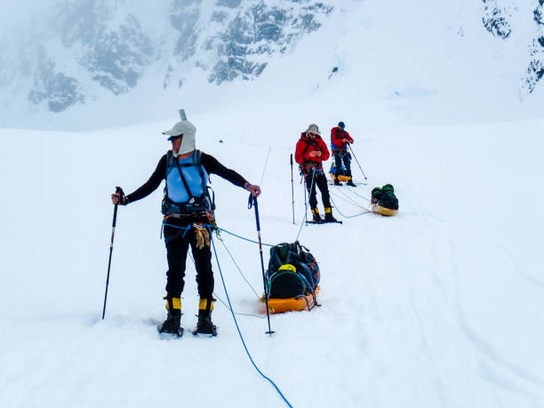 istock Hiking group walking on snowy trail in mountain 1152451180