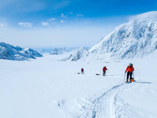 istock Hiking group walking on snowy trail in mountain 1152451216