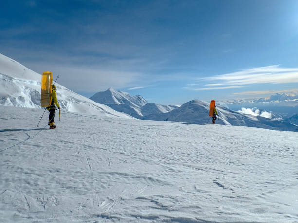 istock Hiking group walking on snowy trail in mountain 1152451278