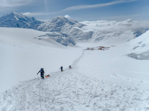 istock Hiking group walking on snowy trail in mountain 1152451285