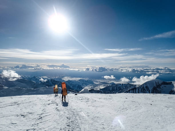 istock Hiking group walking on snowy trail in mountain 1152451289