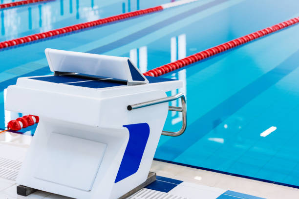 istock Swimming pool with marked red and white lanes. Empty swimming pool without people with quiet standing water. Water sports in indoor pool. 1152451298