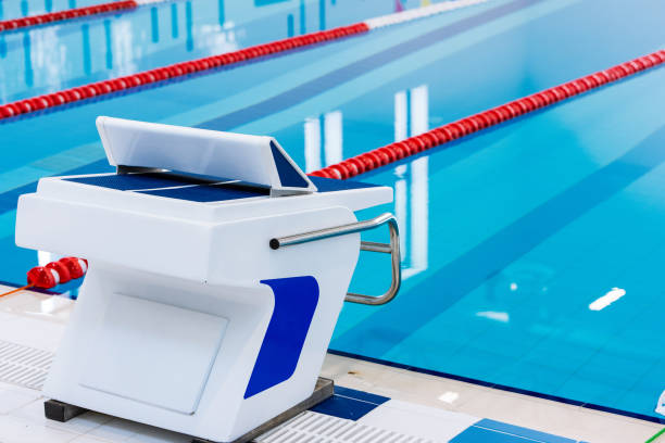 istock Swimming pool with marked red and white lanes. Empty swimming pool without people with quiet standing water. Water sports in indoor pool. 1152451299
