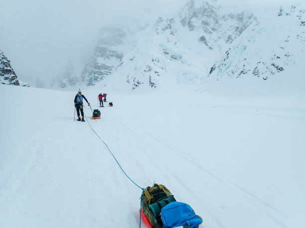 istock Hiking group walking on snowy trail in mountain 1152451308