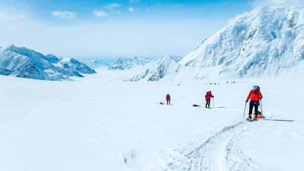 istock Hiking group walking on snowy trail in mountain 1152451316
