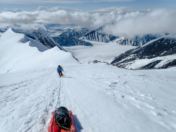 istock Man walking on snowy trail in mountain 1152451326