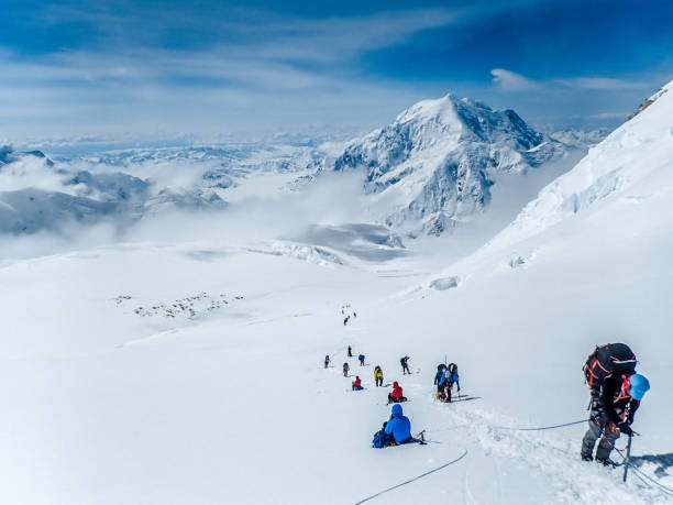 Climbers' silhouettes. Majestic mountain landscape Mountain expedition. Fully equipped climbers on a trail denali mountain stock pictures, royalty-free photos & images