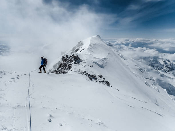 istock Climber silhouette. Majestic mountain landscape 1152451623