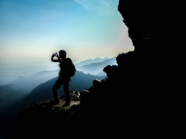 istock Winter mountain adventure. Taking photo on a mountain top 1152451683