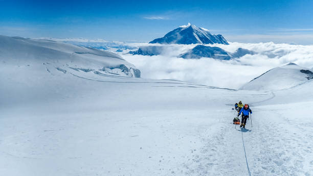 istock Hiking group walking on snowy trail in mountain 1152451727