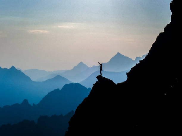 istock Mountain adventure. Man on a mountain top 1152451732