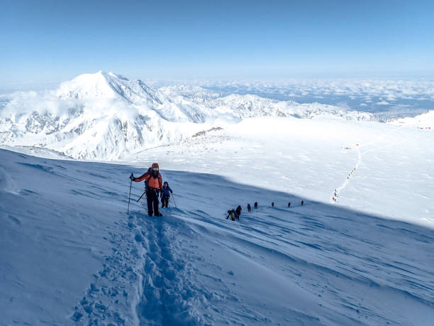 istock Hiking group walking on snowy trail in mountain 1152451773