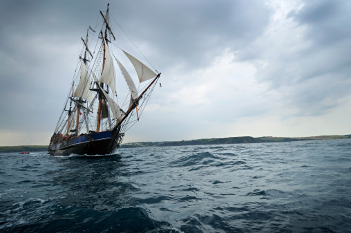 Sinking pirate brigantine on stormy seas
