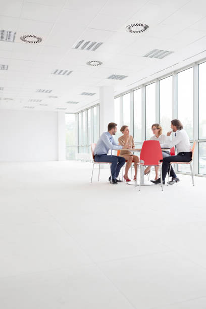 Business colleagues discussing at table in new office