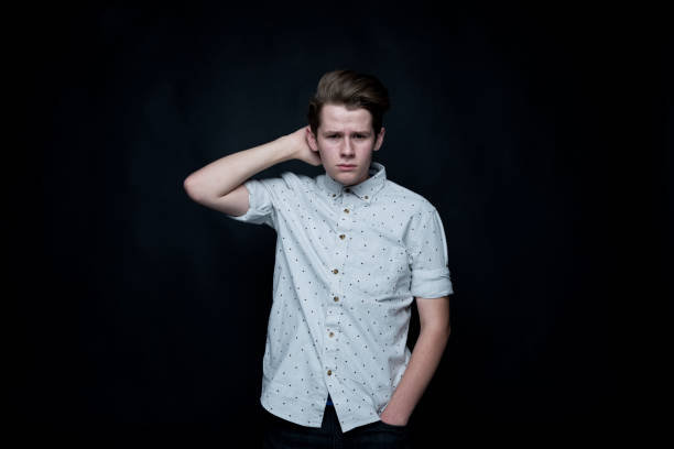 istock Young handsome man standing in front of black background 1152458686