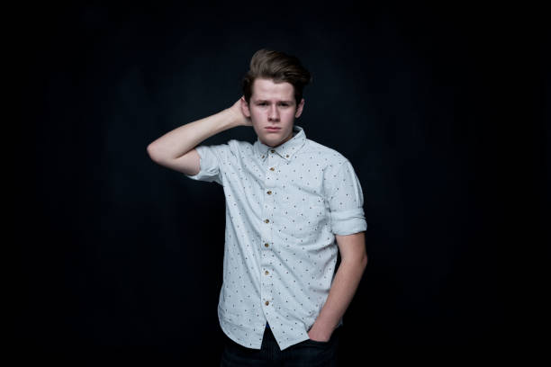 istock Young handsome man standing in front of black background 1152458721