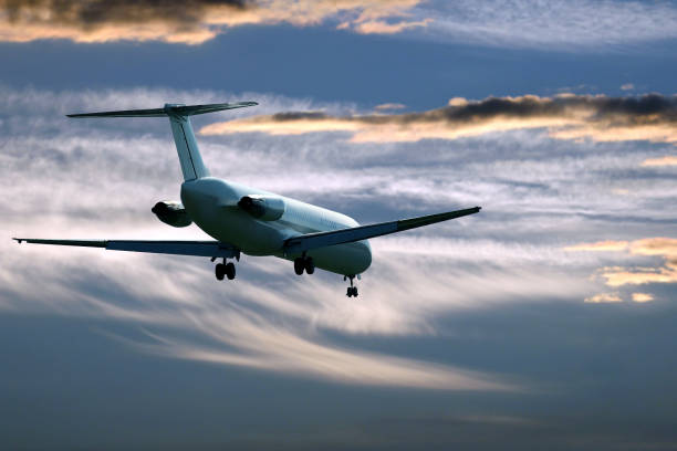 istock passenger jet plane flying in the evening sky at sunset 1152461996