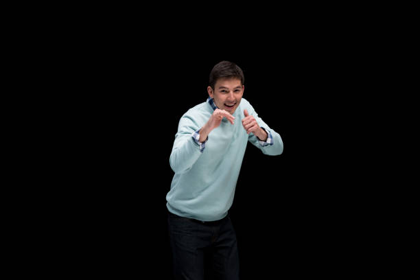 istock Good looking man wearing blue sweater and in fighting stance 1152462248