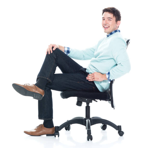 istock Handsome young man sitting and and being happy, side view 1152463735