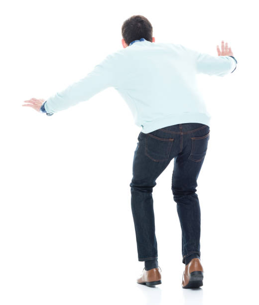 istock Handsome young man walking carefully. Rear view. 1152463980