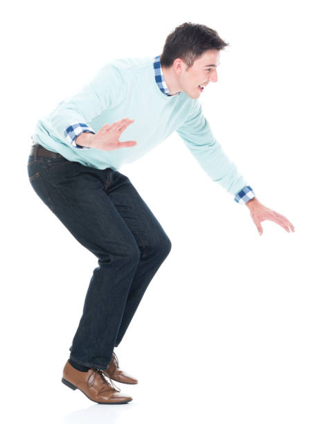 istock Handsome young man walking carefully / tip toe. Side view 1152463986