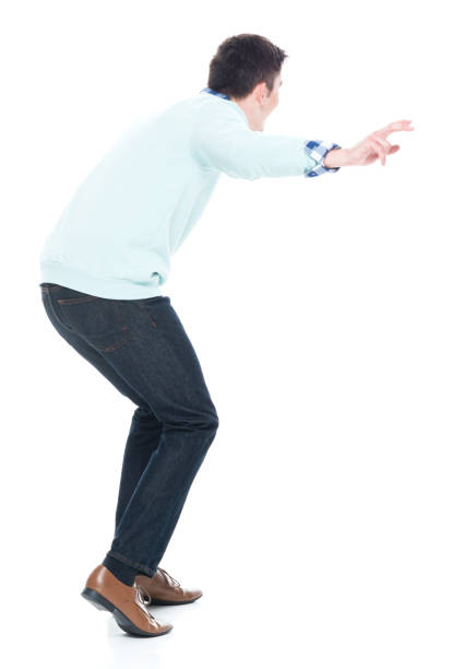 istock Handsome young man walking carefully. Rear view. 1152464028
