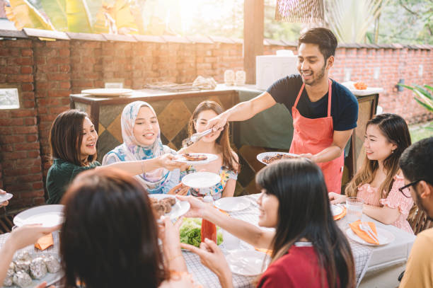 istock a group of multi ethic friends dinner party gathering at villa during weekend for feast 1152465379