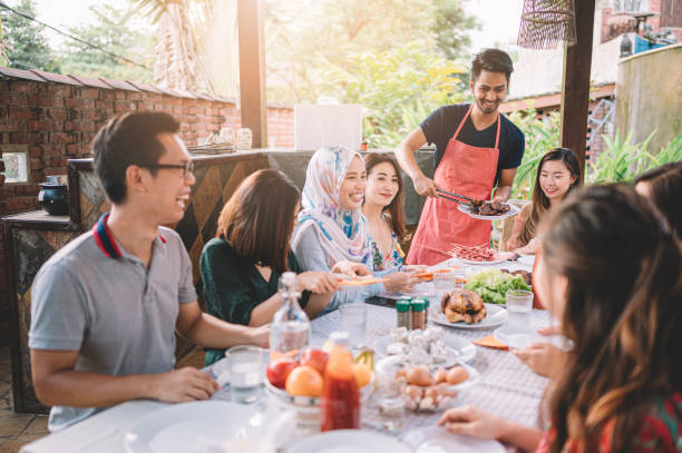 istock a group of multi ethic friends dinner party gathering at villa during weekend for feast 1152465380