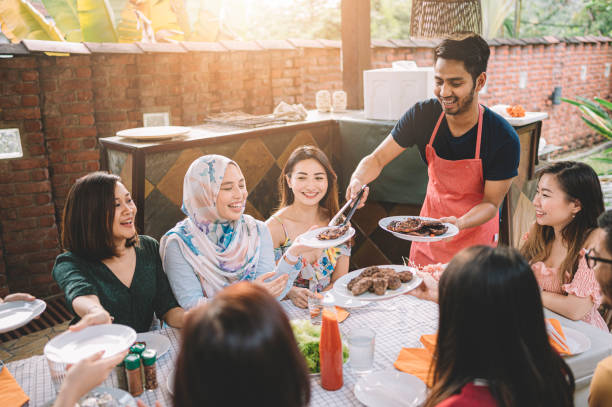 istock a group of multi ethic friends dinner party gathering at villa during weekend for feast 1152465381
